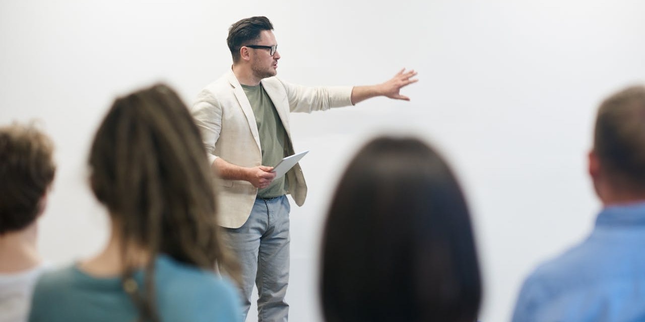 A man presenting a topic in front of an audience